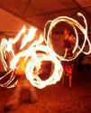 stilts and fire poi with a fire fans circus routine