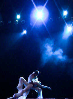 stilt dance performed under UV lights