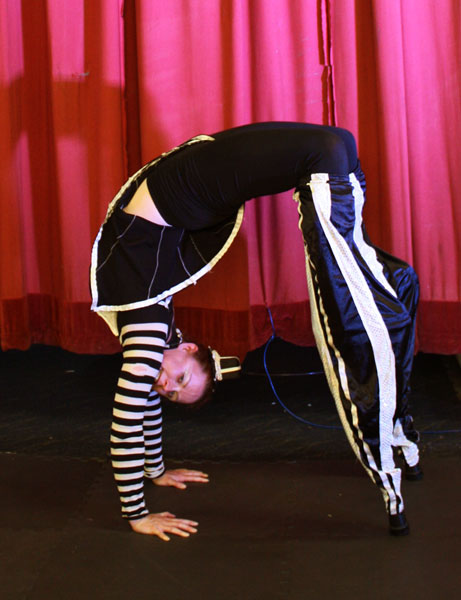 stilt walkers performing next to the red curtain in newcastle, australia, stilt acrobatics, circus, eve everard
