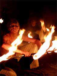 fire staff spinning in performance at woodford folk festival