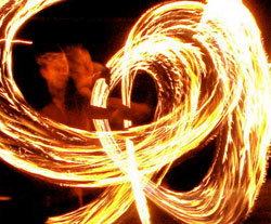 fire staff spinning in performance, fire and light show