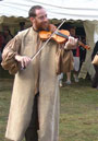 fiddle playing stilt walker
