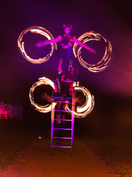 fire performance with free standing  ladder balance, performed by Luke Forrester of Will-o'-the-Wisp and the Great Australian Bite-sized circus